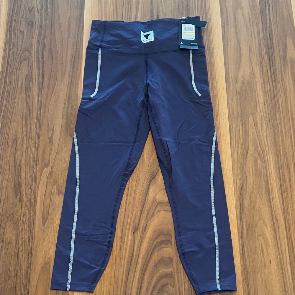 NWT Under Armour Plum Leggings with cool detailing. Size Small.